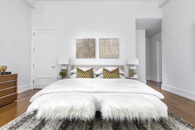 Faux fur stools with acrylic legs add a touch of glamour to this bedroom. [Design Recipes/Tribune News Service]