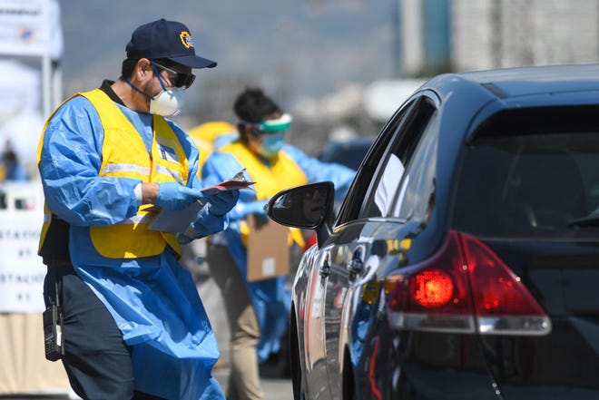 San Bernardino County public health officials conduct drive-thru testing in San Bernardino on March 27, 2020. [JAMES QUIGG FOR THE DAILY PRESS]