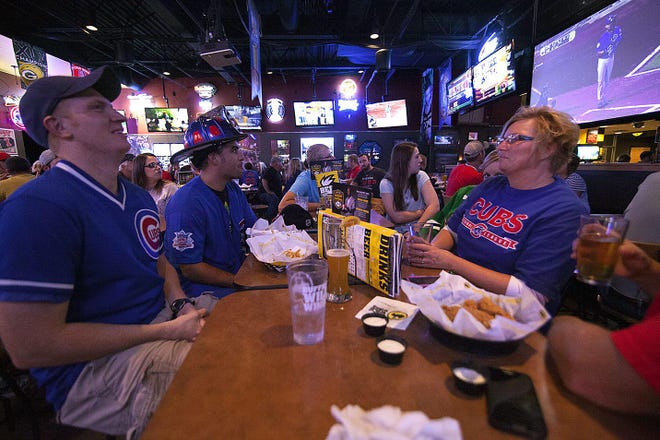 In this file photo, patrons enjoy food and drinks while watching a sporting event at Buffalo Wild Wings in Galesburg. The state will enter the third phase of Restore Illinois on Friday, bringing limited opening opportunities to everywhere from barber shops to small retail stores to restaurants. [REGISTER-MAIL FILE PHOTO]