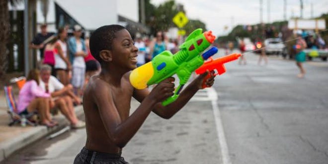 Justin Cox wields two water guns during the Beach Bum Parade on May 21, 2016. [JOSH GALEMORE/SAVANNHNOW.COM FILE PHOTO]