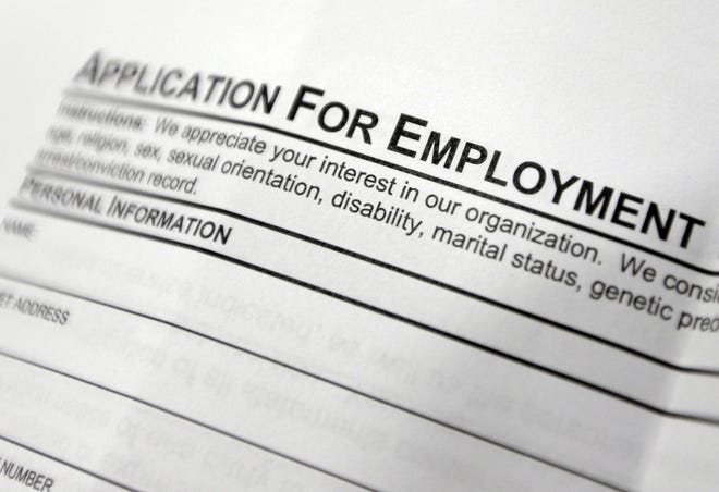 FILE - This April 22, 2014, file photo shows an employment application form on a table during a job fair at Columbia-Greene Community College in Hudson, N.Y. (AP Photo/Mike Groll, File)