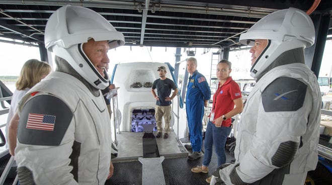 NASA astronauts Doug Hurley, left, and Bob Behnken work with teams from NASA and SpaceX to rehearse crew extraction from SpaceX's Crew Dragon, which will be used to carry humans to the International Space Station, on Aug. 13 at the Trident Basin in Cape Canaveral, Fla. [Bill Ingalls/NASA]