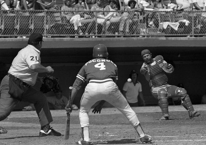 St. Louis Cardinals catcher Gene Tenace throws to the plate as umpire Harry Wendelstadt looks on at West Palm Beach, Fla., Apr. 4, 1981, during exhibition game against the Atlanta Braves. Biff Pocoroba, with bat in hand, reacts. [Ray Howard/Associated Press]