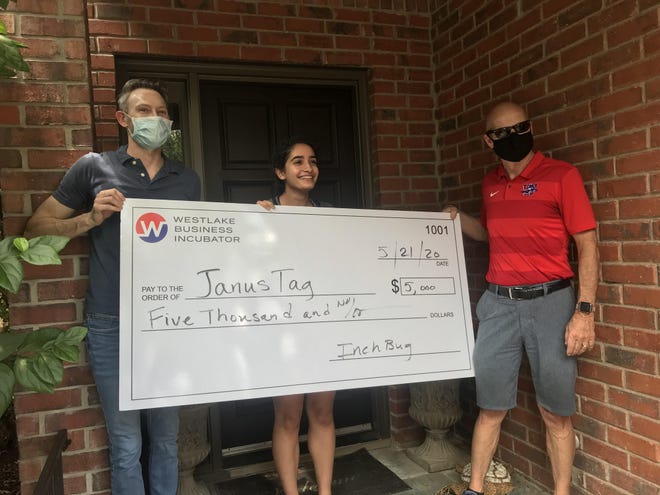Westlake High School Incubator teacher Jeff Nixon and Superintendent Tom Leonard surprised Amelia Azadi with the check on her front porch May 21. [LUZ MORENO-LOZANO/WESTLAKE PICAYUNE]