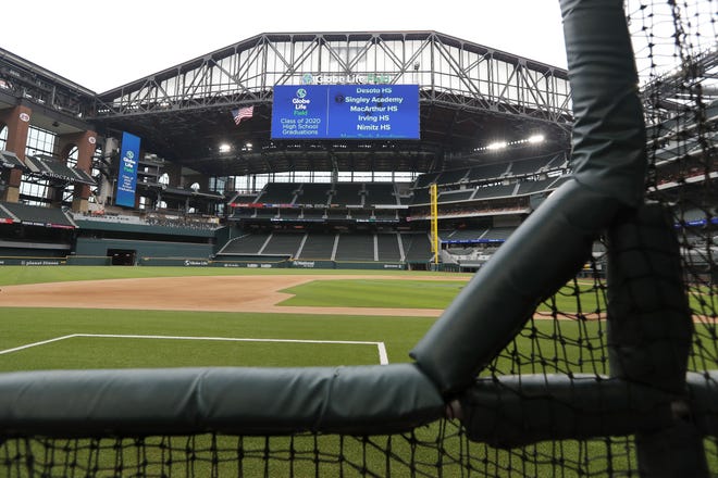 Globe Life Field, the newly built home of the Texas Rangers in Arlington, Texas, sits empty with the roof open Wednesday. MLB would like to start the season around the Fourth of July in empty ballparks and has proposed an 82-game regular season. [Tony Gutierrez/Associated Press]
