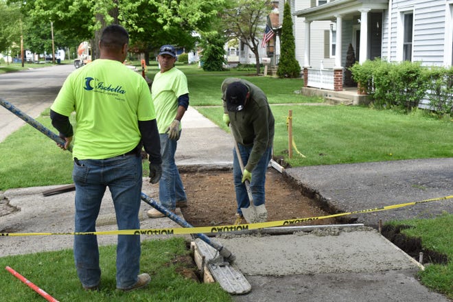 Sidewalk repairs are taking place in the First and Second Wards in Coldwater this summer. [Don Reid photo]
