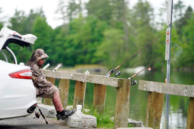 Daniel Hawley fishes for trout using powerbait at Laurel Lake in Lee, Mass. Thursday, May 28, 2020. (Ben Garver/The Berkshire Eagle via AP)
