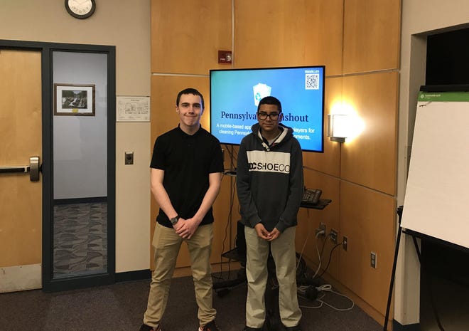 MCTI freshmen Kyle Jones, left, and Jason Herrera, right, pose at the regional judging event for PennDOT’s 2019-20 Innovations Challenge at the Engineering District 5 office. The pair won the statewide competition with their “Pennsylvania Trashout” website and app, which rewards users for picking up trash in their communities while competing for prizes. [PHOTO PROVIDED BY PENNDOT]