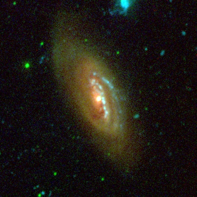 NGC 4569 is one of the largest and brightest spiral galaxies found in the Virgo Galaxy Cluster. It was photographed by NASA’s Galaxy Evolution Explorer. [NASA/JPL-Caltech/Palomar/Public domain/Wikimedia Commons]