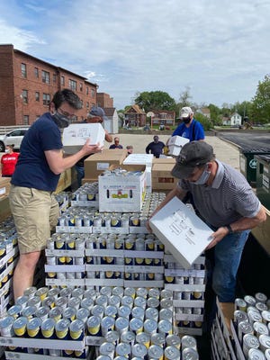 Volunteers from Galesburg Lions Club gathered at First Presbyterian Church on May 23 to move approximately $10,000 in nonperishable food to store at VNA Community Services. The food supply will now be used to feed children receiving meals from United Way of Knox County’s daily lunch program. [SUBMITTED PHOTO]