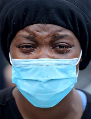 A woman cries as she joins protesters at Union Square in Manhattan on Saturday, May 30, 2020. Several thousand people rallied and marched through lower Manhattan to protest the death of George Floyd in Minneapolis earlier in the week. (Seth Harrison/The Journal News)