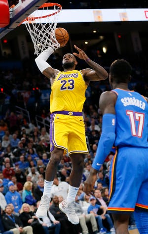 Los Angeles' LeBron James (23) dunks the ball in front of Oklahoma City's Dennis Schroder (17) in the third quarter during an NBA basketball game between the Oklahoma City Thunder and the Los Angeles Lakers at Chesapeake Energy Arena in Oklahoma City, Friday, Nov. 22, 2019. [The Oklahoman Archives]