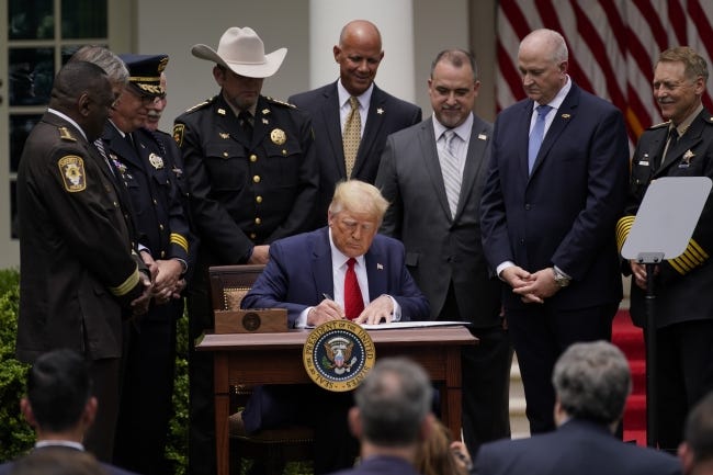 President Trump signs an executive order on police reform, Tuesday, June 16, in Washington. [AP Photo/Evan Vucci]