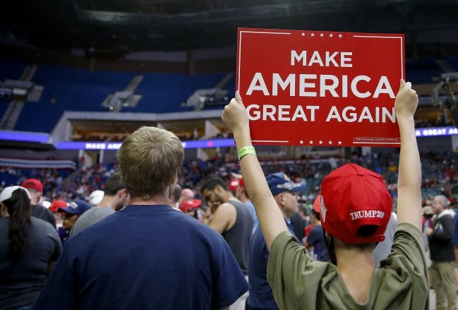A Trump supporter holds a sign before the president's rally at the BOK Center in Tulsa on Saturday. [Sarah Phipps/The Oklahoman]