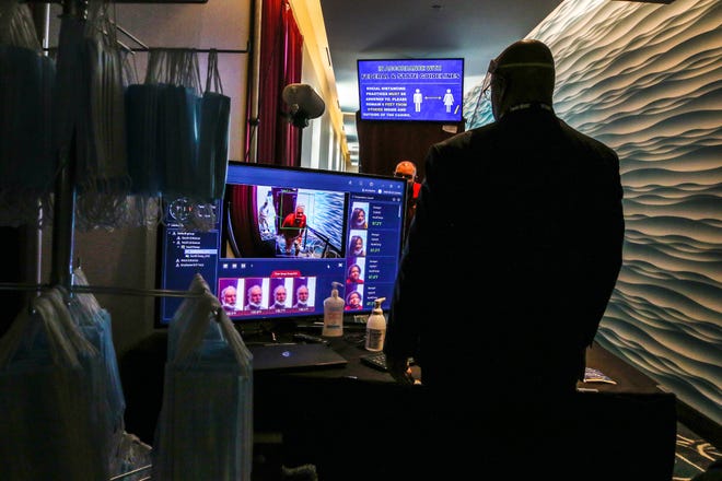 Twin River Casino's new normal: Peter Hill monitors incoming customers for fevers using scanner technology at the north entrance to the casino. [The Providence Journal / David DelPoio]
