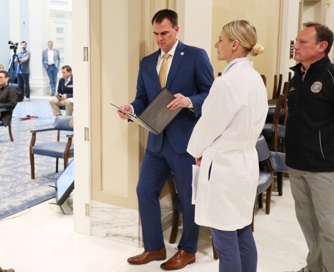 Gov. Kevin Stitt, Kayse Shrum and Jerome Loughridge wait outside of the Blue Room before the media briefing for the Governor's Solution Task Force to provide an update on Oklahoma's COVID-19 response in the Blue Room of the Capitol Wednesday, April 15, 2020. [Photo by Doug Hoke/The Oklahoman]