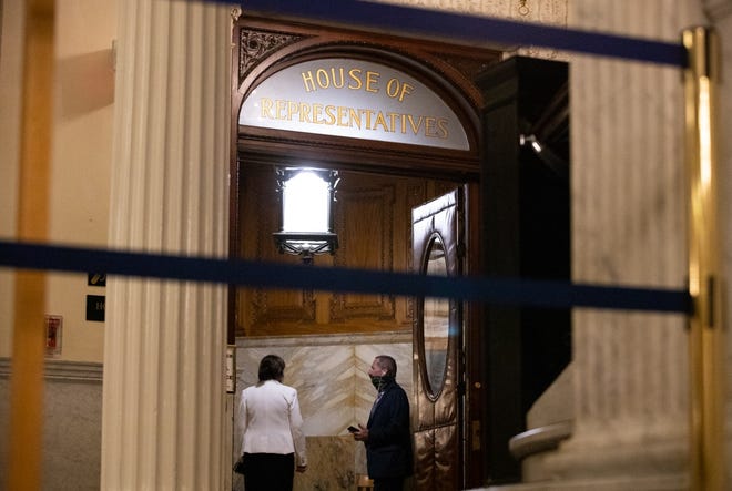 As the third day of House debate on policing reform stretched into the night, House Judiciary Chair Claire Cronin and Rep. Paul Tucker, a retired police chief, conversed in a chamber entryway. [Sam Doran/SHNS]