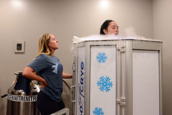Sierra Brown, left, of 740YCryo, assists customer Desiree Tysinger during a cryotherapy session. The business, which opened July 27, is the first of its kind in Zanesville.