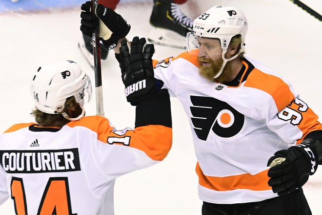 Philadelphia Flyers right wing Jakub Voracek (93) celebrates his goal with teammate Sean Couturier (14) during first period NHL Eastern Conference Stanley Cup playoff hockey action against the Montreal Canadiens, in Toronto, Sunday. (THE CANADIAN PRESS/Frank Gunn)