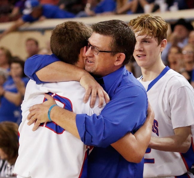 Fort Cobb-Broxton boys basketball coach Scott Hines, shown hugging his oldest son, Cameron, in the final minute of his team's 2016 state championship, has been hospitalized since July 17 due to COVID-19 and its effects. [The Oklahoman Archives]