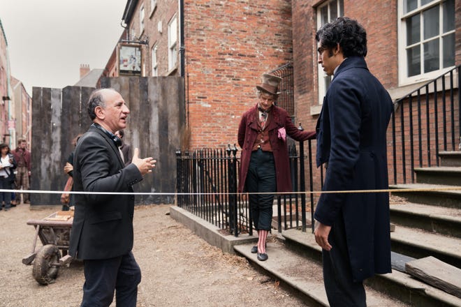 Armando Iannucci gives direction to Dev Patel and Peter Capaldi. [Searchlight Pictures]