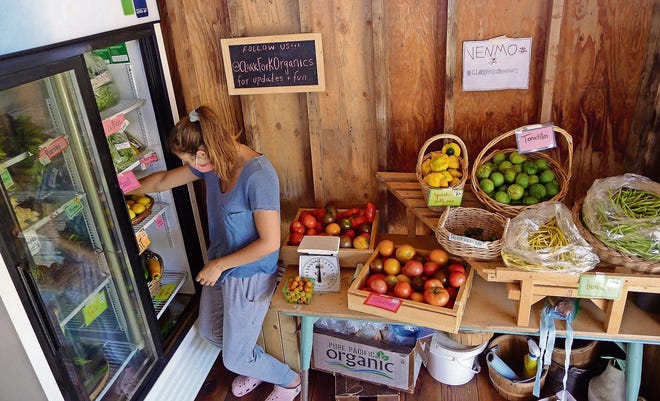 Tasha Slotinck organizes the produce cooler at Clark Fork Organics in Missoula, Montana. [ARI LEVAUX]