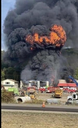 Smoke and flames shoot out after an explosion at T&R Towing and Service in Bath Thursday afternoon. (PHOTO PROVIDED)