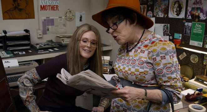 Gloria Steinem (Julianne Moore) checks out the headlines with Bella Abzug (Bette Midler). [Roadside Attractions]