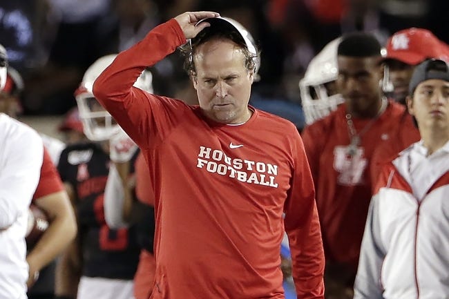Houston head coach Dana Holgorsen, center, reacts during the second half of a game against SMU, in Houston on Oct. 24, 2019. In more than 25 years of coaching college football, Houston's Dana Holgorsen had to deal with only two games canceled before this season. This year alone, he and the Cougars have had five games either canceled or postponed because of the pandemic, pushing their season opener back again and again. [AP Photo/Michael Wyke, File]
