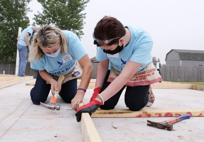 Oklahoma City Police Capt. Susan Kennedy and Kimley Deutsch, a Life.Church member, nail studs for a wall during the "Faith & Blue Weekend" Habitat for Humanity home building project on Friday in the metro. [Doug Hoke/The Oklahoman]