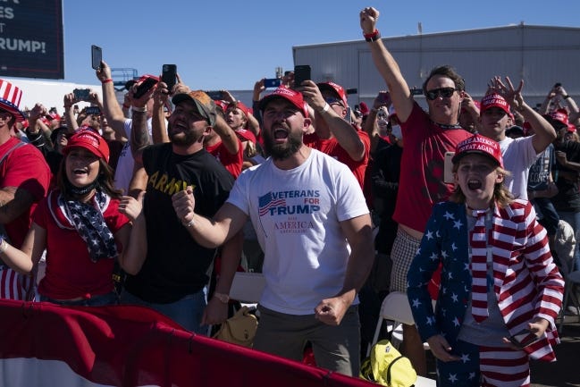 Supporters of President Donald Trump cheer as he arrives for a campaign rally at Laughlin/Bullhead International Airport, Wednesday, Oct. 28, 2020, in Bullhead City, Ariz. (AP Photo/Evan Vucci)