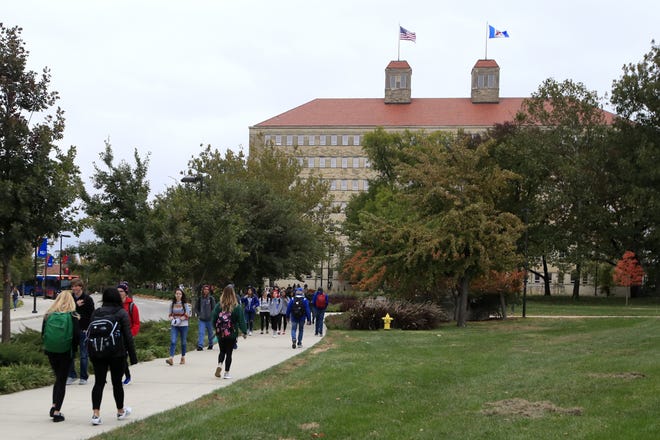 Students walk in front of Fraser Hall on the University of Kansas campus in Lawrence, Kansas, in 2019. [AP File Photo/Orlin Wagner]