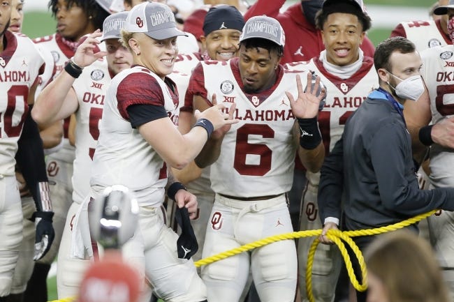 Spencer Rattler (7) and Tre Brown (6) celebrate the Sooners' 27-21 win Saturday over Iowa State in the Big 12 title game in Arlington, Texas. [Bryan Terry/The Oklahoman]