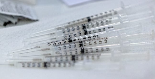 Syringes with the Covid-19 vaccine are prepared for distribution in the Cleveland County Health Department's vaccine pod on Jan. 7. [Chris Landsberger/The Oklahoman]