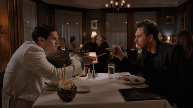 The Kid (Jake Robinson, left) and The Narrator (Thomas Sadoski) have an argumentative dinner. [Gravitas Ventures]