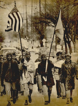 Boy Scouts from Post 257 march 50 years ago at the beginning of Black Heritage Week. About 200 people followed the color guard in a parade in northeast Oklahoma City to commemorate the observance week. This photo was published Feb. 7, 1971, in The Sunday Oklahoman. [JIM ARGO/THE OKLAHOMAN ARCHIVES]