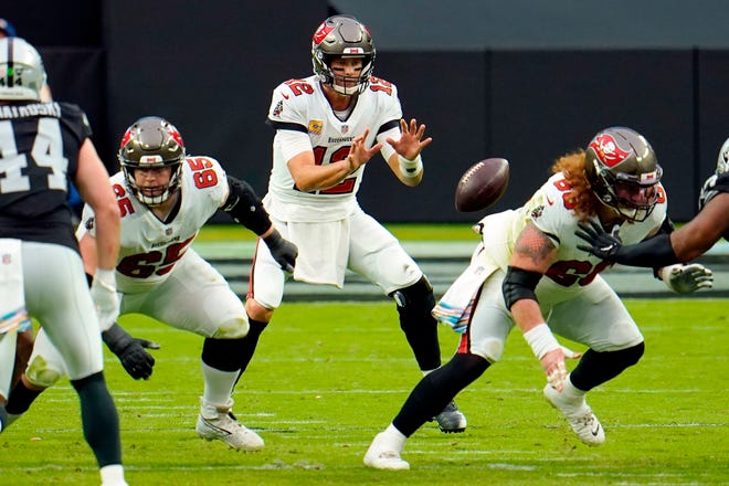 FILE - In this Oct. 25, 2020, file photo, Tampa Bay Buccaneers quarterback Tom Brady (12) receives the ball from center Ryan Jensen (66) during the first half of the team's NFL football game against the Las Vegas Raiders in Las Vegas. âIt didnât take too long, really,â Jensen said of building a rapport with Brady. âWe both kind of have a fiery spirit and, you know, I think that has helped us quite a bit, getting to know each other and knowing what weâre about.â (AP Photo/Jeff Bottari, File)