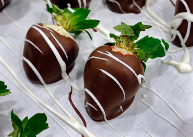 White chocolate is drizzled on chocolate-covered strawberries at Bedre Fine Chocolate on Friday, Feb. 6, 2015 in Davis, Okla. [The Oklahoman Archives]
