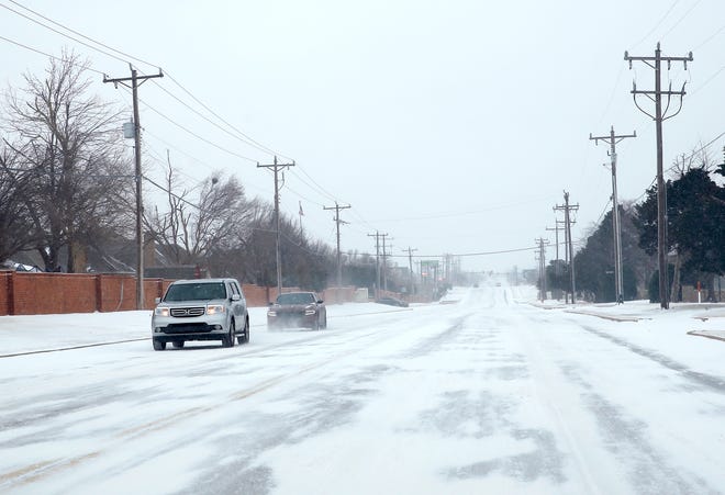Cars travel east on NW 164th in northwest Oklahoma City, Sunday, Feb. 14, 2021. Photo by Sarah Phipps, The Oklahoman