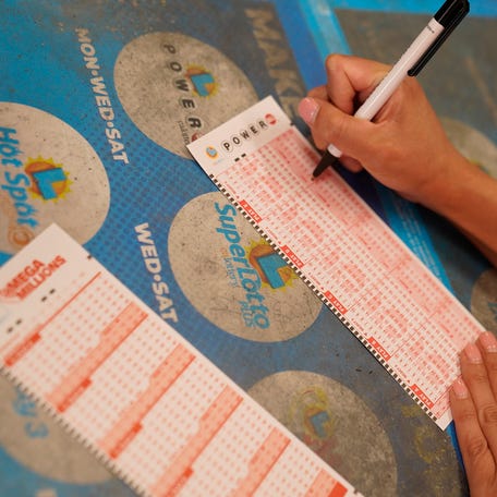 A customer chooses Powerball numbers at Won Won Mini Market liquor store in Los Angeles on Tuesday, July 18, 2023. The Powerball jackpot rose yet again to an estimated $1 billion after no winning ticket was sold for the latest drawing.