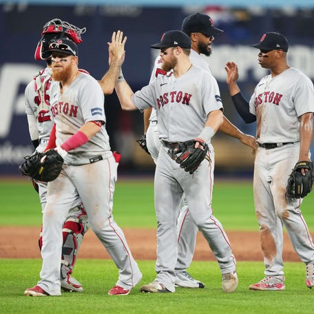Red Sox relief pitcher Kenley Jansen celebrates the win with third baseman Rafael Dever.