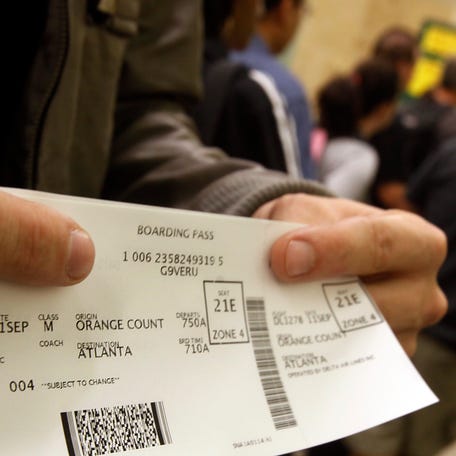A passenger displays his boarding pass at John Wayne Orange County Airport in Santa Ana, California, on Sept. 11, 2011.