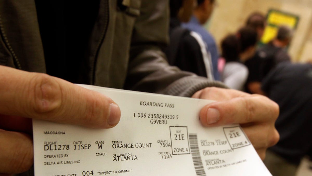 A passenger displays his boarding pass at John Wayne Orange County Airport in Santa Ana, California, on Sept. 11, 2011.