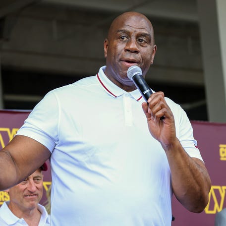 Magic Johnson delivers remarks during a press conference introducing the Washington Commanders' new ownership group at on Friday.