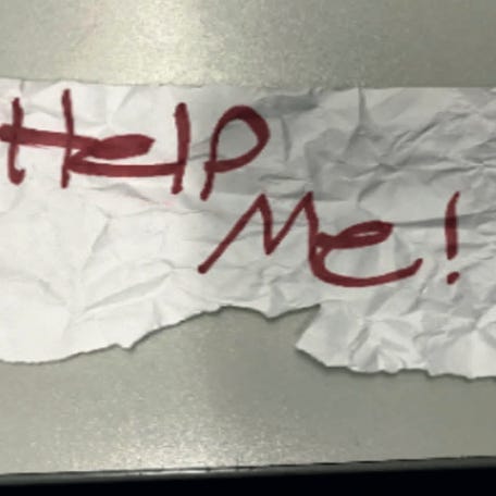 In this undated photo released by the U.S Department of Justice is a "Help Me!" sign used by a 13-year-old girl kidnapped in Texas. The girl was rescued in Southern California on July 9, 2023, when passersby saw her hold up the sign in a parked car, police said. The rescue occurred in Long Beach when officers responded to a trouble call and found the "visibly emotional and distressed girl," police said in a press release Thursday, July 20.