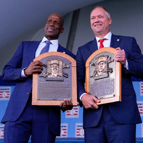 Fred McGriff, left, Scott Rolen pose for a photo with their new plaques after being inducted into the National Baseball Hall of Fame.