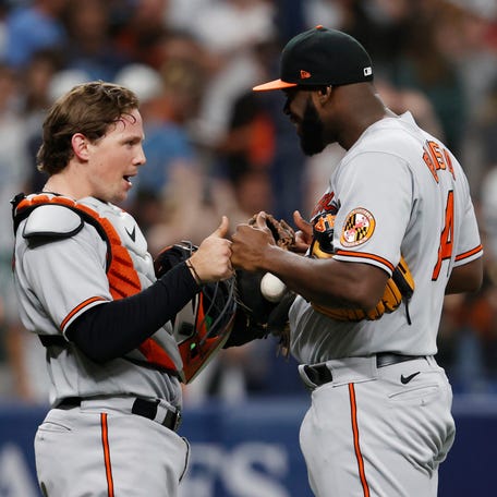 Adley Rutschman and Felix Bautista celebrate after the Orioles' win at Tropicana Field on Sunday.