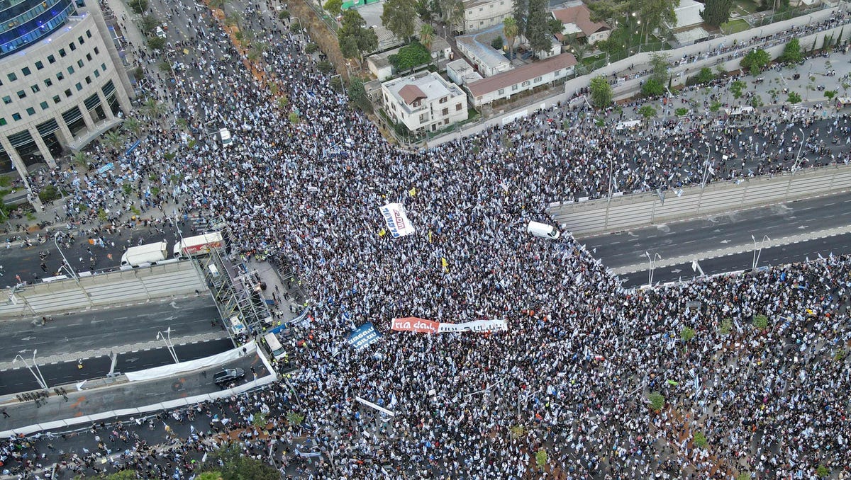 An aerial view shows right-wing demonstrators backing the Israeli government and its reform plans rallying in Tel Aviv, the epicentre of 29 straight weeks of anti-government protests, on July 23, 2023.