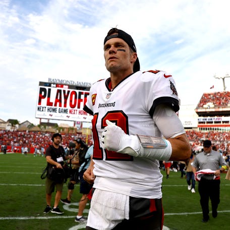 Tom Brady runs off the field after the Tampa Bay Buccaneers beat the Carolina Panthers in January.