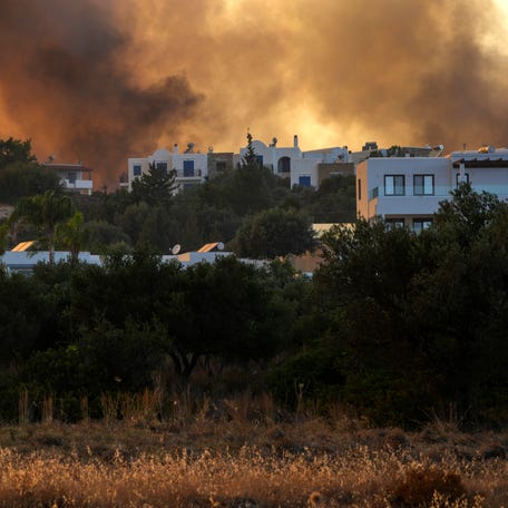A wildfire burns in Gennadi village, on the Aegean Sea island of Rhodes in southeastern Greece on July 25, 2023.